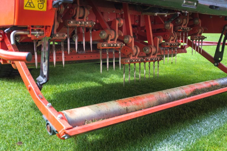Detail of aeration machine during grasslands football field